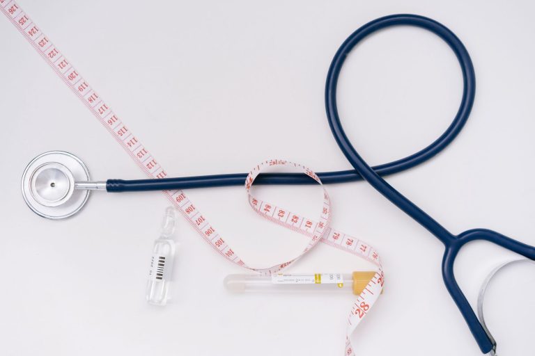 A stethoscope, ampoule, and tape measure on a white background symbolize healthcare essentials. — 3 Things You Need to Know a