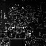 Detailed black and white photo of a circuit board showing intricate components, perfect for tech projects. — 4 Impeccable Ben