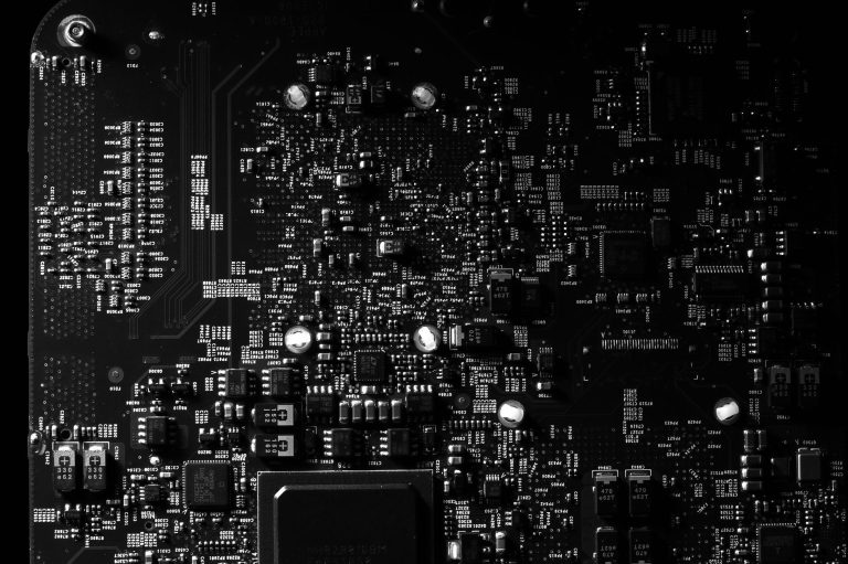 Detailed black and white photo of a circuit board showing intricate components, perfect for tech projects. — 4 Impeccable Ben