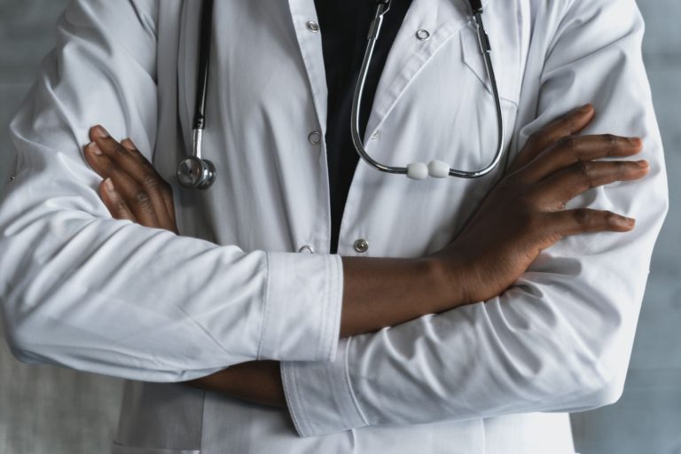 Close-up of a confident doctor in a lab coat standing with crossed arms and stethoscope. — 5 Reasons to Choose Laparoscopic H