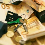Euro currency with house keys and miniature models, symbolizing real estate investment. — 5 reasons to use a loan app to appl