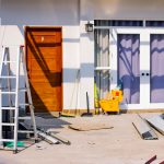 Front entrance of a house under renovation with tools and materials scattered around. — 5 things to consider when buying curt