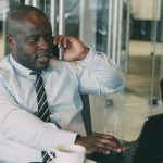 Professional man multitasking, talking on the phone while using a laptop in an office. — A Comprehensive Guide to Installing