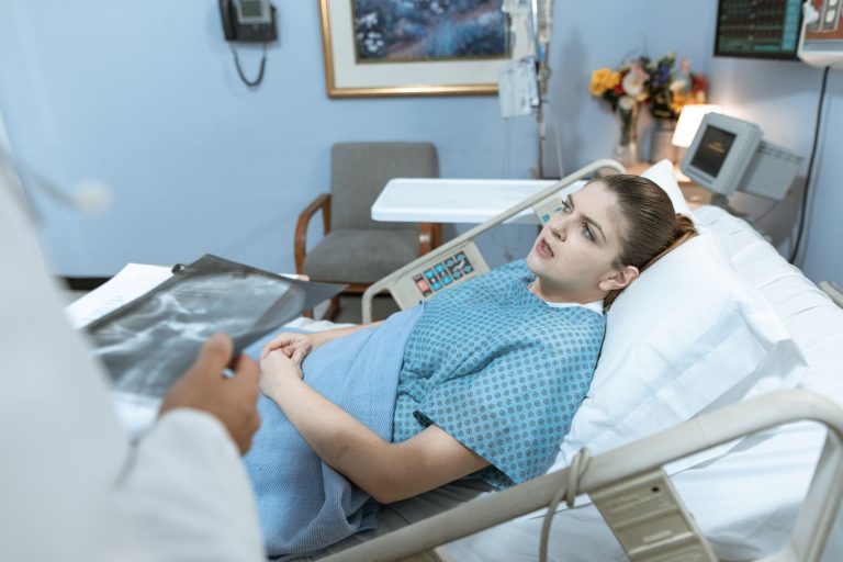 Caucasian woman in hospital bed receiving care from healthcare professional. — A Perfect Fit for My Machine