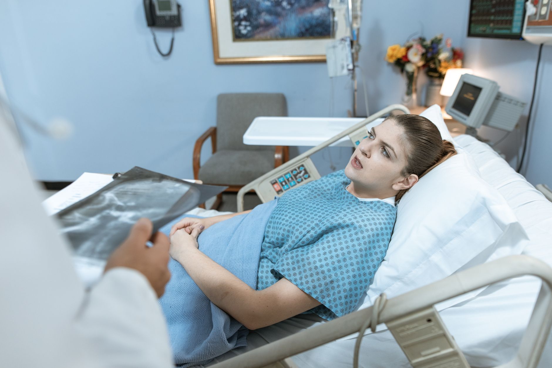 Caucasian woman in hospital bed receiving care from healthcare professional. — A Perfect Fit for My Machine