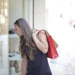 A woman window shopping with colorful bags on a sunny day, exploring store displays. — Alternatives to Go for if High Heels S
