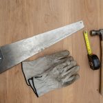 Flat lay of essential carpentry tools including a saw, hammer, and tape measure on wooden surface. — Are the shaggy rugs a be
