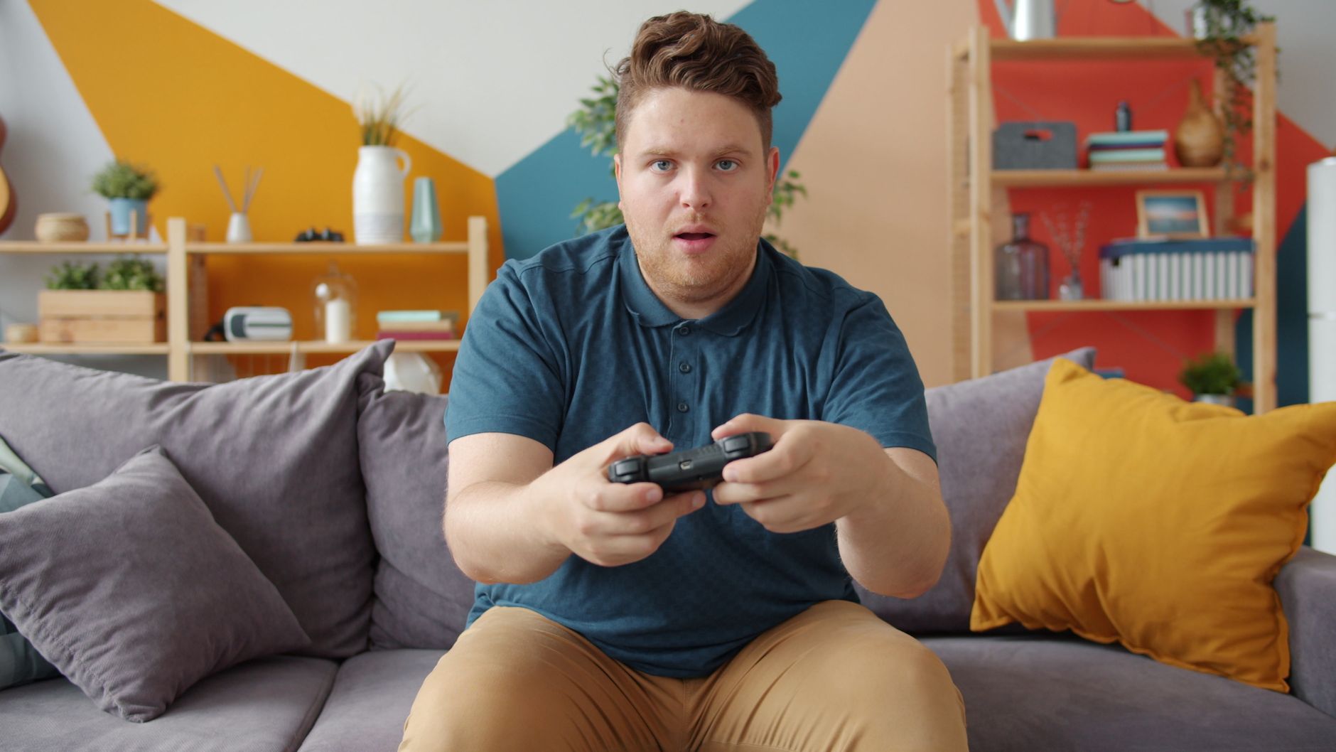 A young man intensely playing video games in a modern living room setting. — Best Online Casino Games for New Players: A Begi