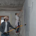 A couple painting a room together, highlighting teamwork in home renovation. — Cheap Skirting Board Ideas to Elevate Your Hom