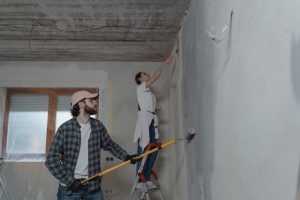 A couple painting a room together, highlighting teamwork in home renovation. — Cheap Skirting Board Ideas to Elevate Your Hom