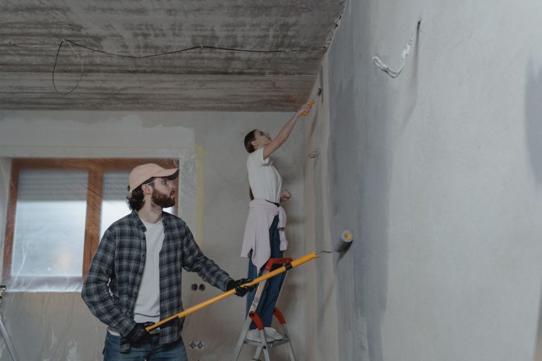 A couple painting a room together, highlighting teamwork in home renovation. — Cheap Skirting Board Ideas to Elevate Your Hom