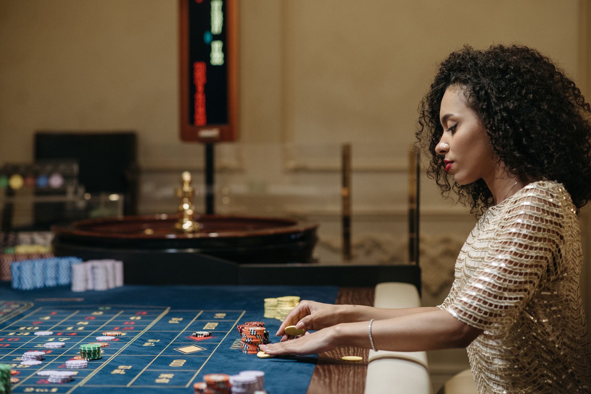 Stylish woman in a casino setting, playing roulette with stacks of chips. — Choosing the Private toto For A Safe Playground