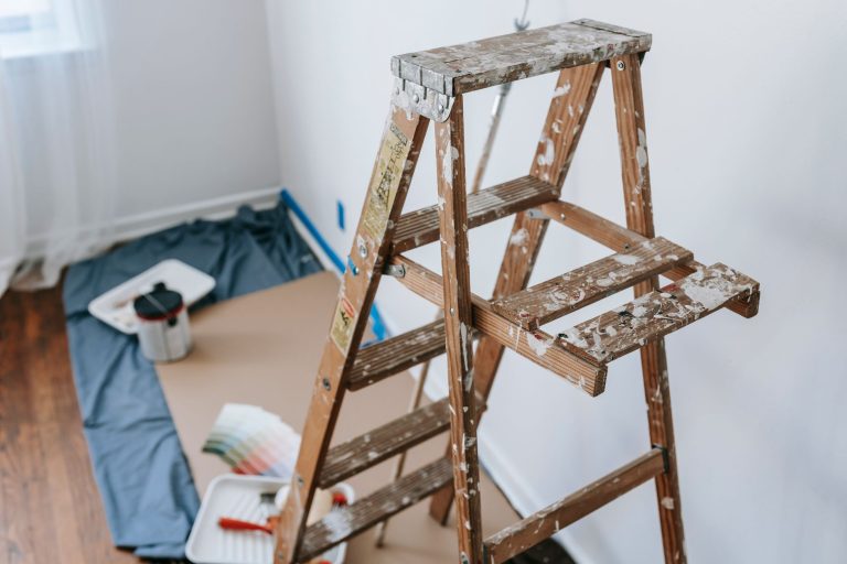 A messy stepladder and painting tools set up for a home interior renovation project. — Computerized Driveway Gates Price 2021