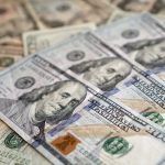 Detailed view of US dollar banknotes showcasing currency and investment themes. — Covered and Uncovered Interest Rate Parity