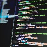 Close-up of colorful programming code displayed on a computer monitor with a dark background. — Current innovation use instan