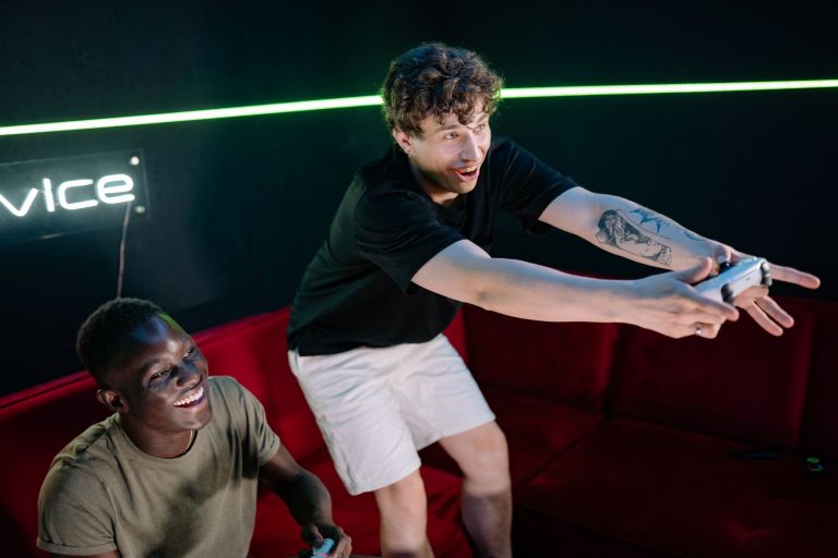 Two young men having fun playing video games in a cozy indoor setting. — Current state of affairs of Online Gambling: