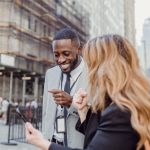 Two business professionals engage in lively conversation on an urban street, sharing insights. — Discover the Perfect Picnic