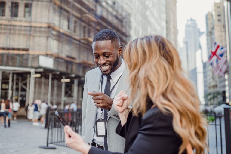Two business professionals engage in lively conversation on an urban street, sharing insights. — Discover the Perfect Picnic
