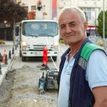 Smiling construction worker on a city street with vehicles and buildings. — Enjoy the bonus offers on the verification site?
