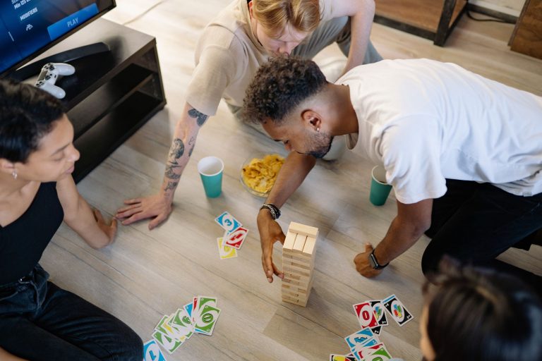 Group of friends enjoying board and card games in a cozy home setting. — Esports Continue to Trend Across the Board