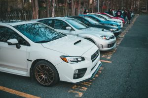 Vibrant lineup of parked cars in an outdoor lot, showcasing various models and colors. — Essential Tips for Preventing Auto G