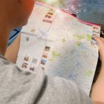Traveler studying a map for directions, symbolizing exploration and adventure. — Festivities and the Appropriate Setups for E
