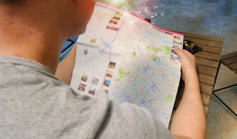 Traveler studying a map for directions, symbolizing exploration and adventure. — Festivities and the Appropriate Setups for E