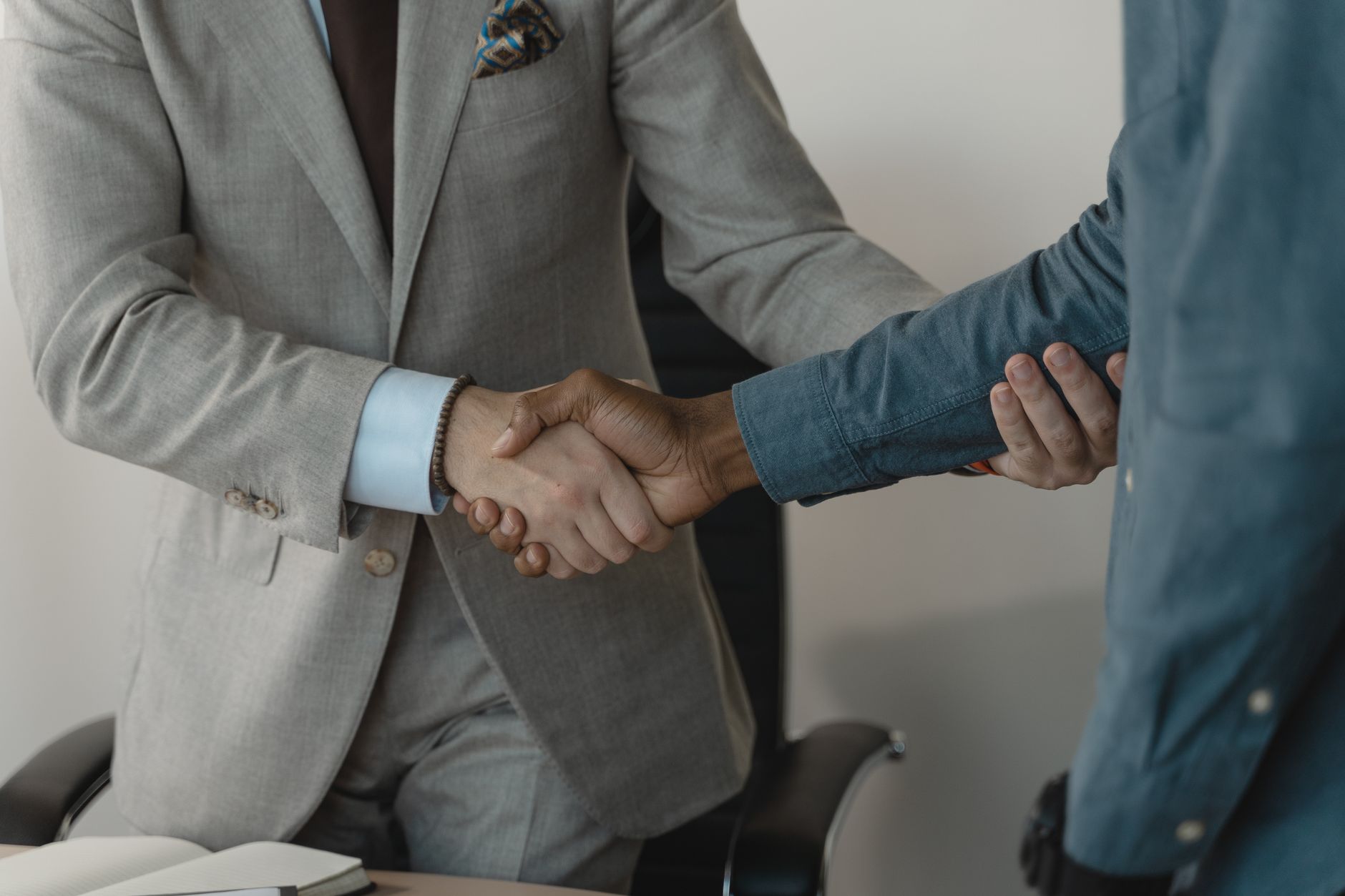 Image of a professional handshake between two businessmen in an office setting. — Find the Right Waste Paper Supplier for You
