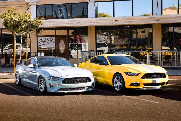 A blue and yellow sports car parked in front of a cafe in an urban area. — General Information On Auto Maintenance And Repair