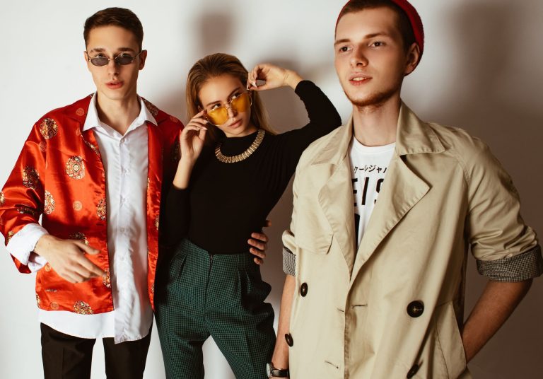 Fashionable portrait of three adults showcasing trendy outfits and accessories indoors. — Get Decorated With Gildan G500 Whol