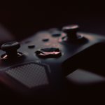 A close-up shot of a game controller in low light, highlighting its design and buttons. — Get the Most out of UFABET