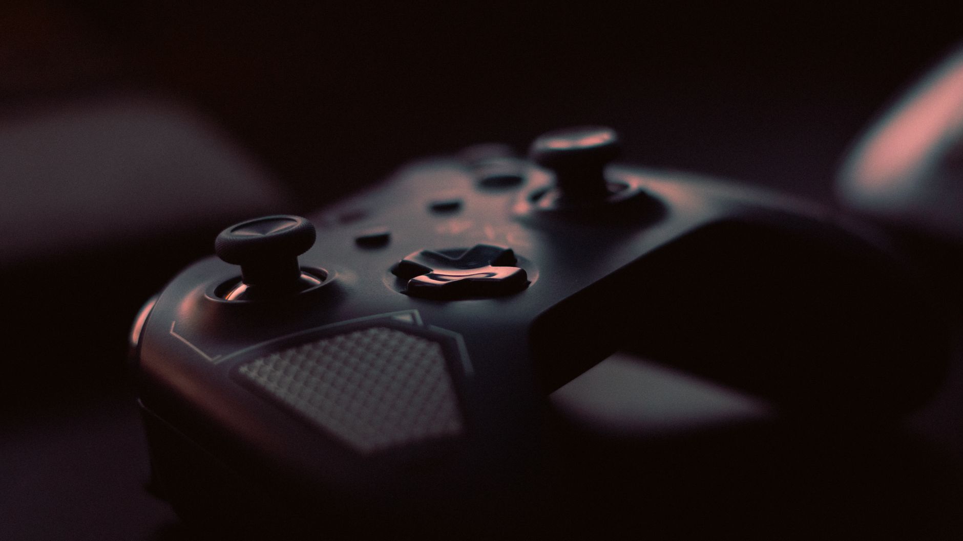 A close-up shot of a game controller in low light, highlighting its design and buttons. — Get the Most out of UFABET