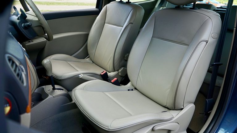 Spacious car interior featuring contemporary leather seats and a steering wheel. — Guide on hiring a credible house paint con