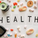 Creative flat lay with sweets around a 'HEALTH' text and monitoring device, symbolizing diabetes awareness. — How can I remov