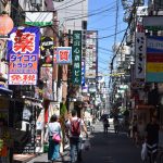 Bustling urban street in Osaka with colorful advertisements and pedestrians in daylight. — How to File Your Status in the Inc