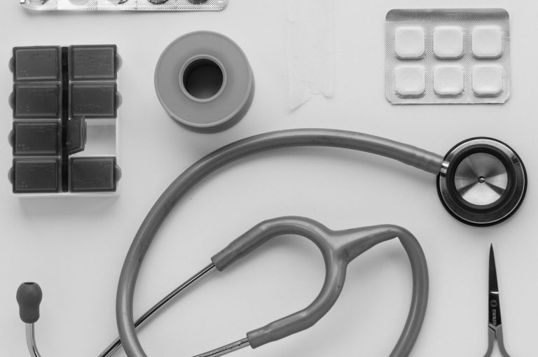 Top view of medical instruments and pills arranged on a white background. — How To Get Precaution From The Klonopin?