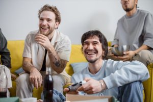 Group of friends laughing and enjoying video games together indoors. — How to Make an Escape Room For Kids