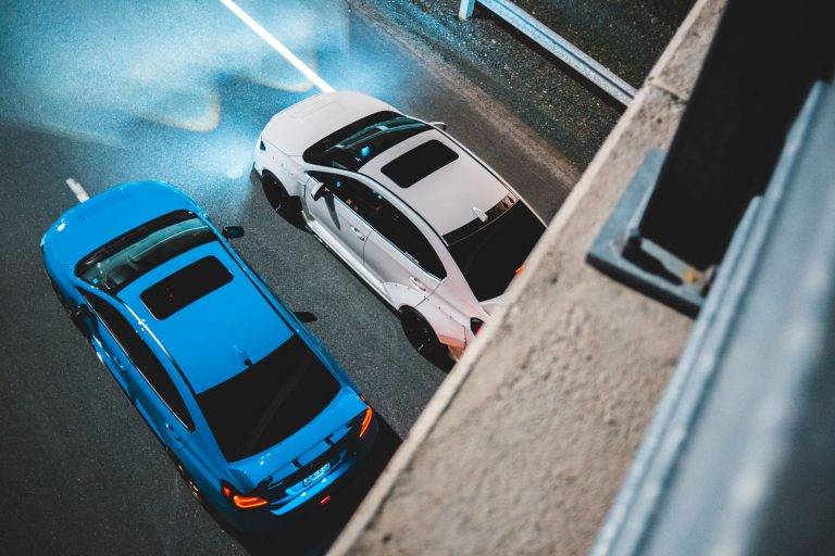From above of modern automobiles with bright lights riding on asphalt road with marking lines at night — How To Protect Your