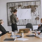 Group of business professionals discussing strategies with growth chart in conference room. — How to Start Your Own Empty Lip