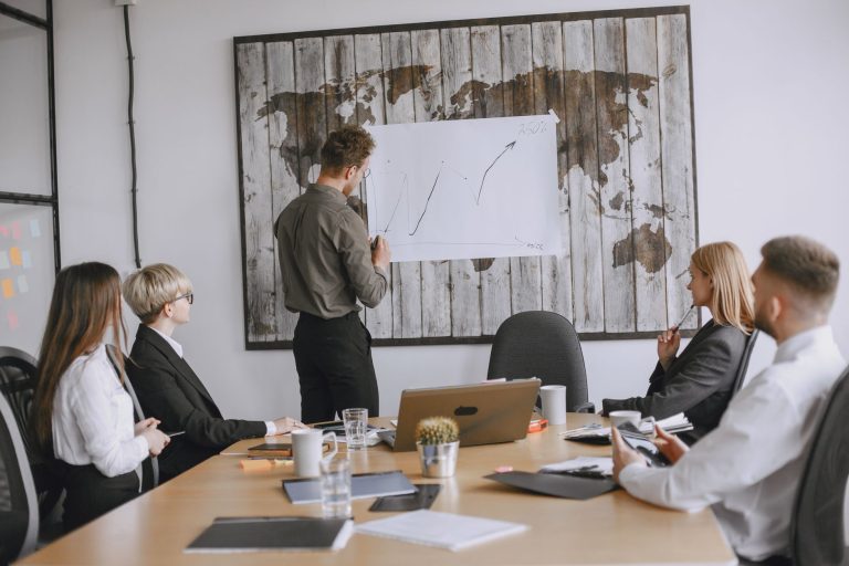 Group of business professionals discussing strategies with growth chart in conference room. — How to Start Your Own Empty Lip