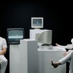 A modern depiction with vintage computers and individuals in a futuristic lab setting. — Is Your Business Compliant with Fire