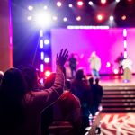 Vibrant live concert scene with a cheering audience and colorful stage lighting effects. — Know More About 123movies