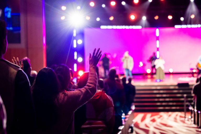 Vibrant live concert scene with a cheering audience and colorful stage lighting effects. — Know More About 123movies