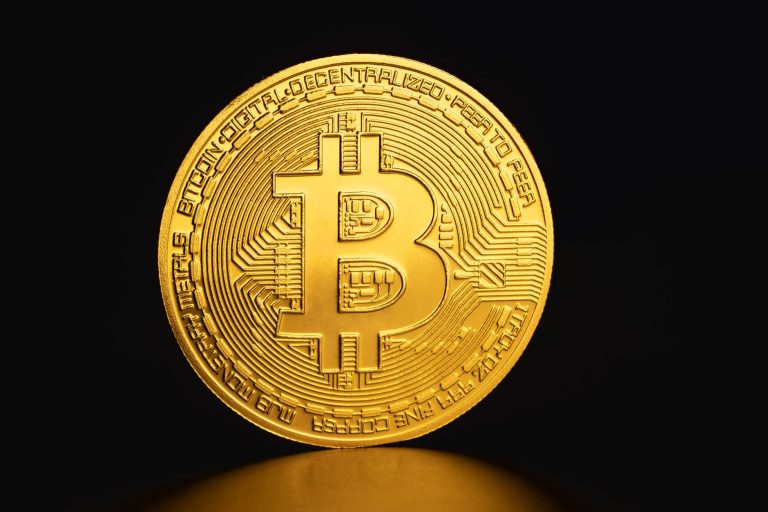 Close-up of a golden Bitcoin coin on a dark background symbolizing cryptocurrency and digital finance. — Learn the reasons wh
