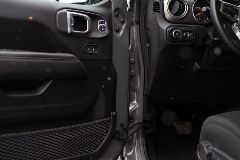 Detailed interior shot of a car showing the door panel and part of the dashboard. — Let Us Buy Leather Shoulder Holsters!