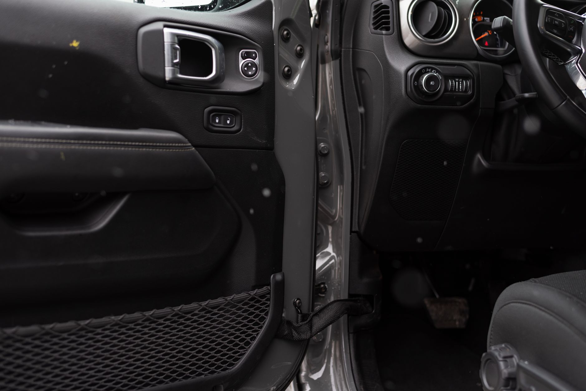 Detailed interior shot of a car showing the door panel and part of the dashboard. — Let Us Buy Leather Shoulder Holsters!