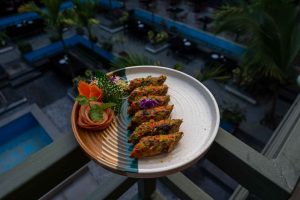 Delicious gourmet vegetable dish served on a balcony with an elegant presentation and a scenic outdoor background. — Magic Mu