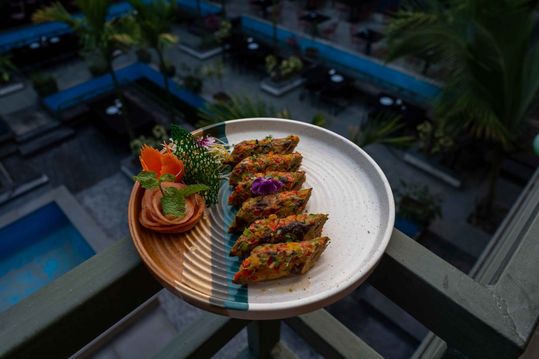 Delicious gourmet vegetable dish served on a balcony with an elegant presentation and a scenic outdoor background. — Magic Mu