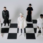 Stylish fashion models in black and white outfits on a chessboard backdrop. — Make your Lifestyle More Efficient With The 6th
