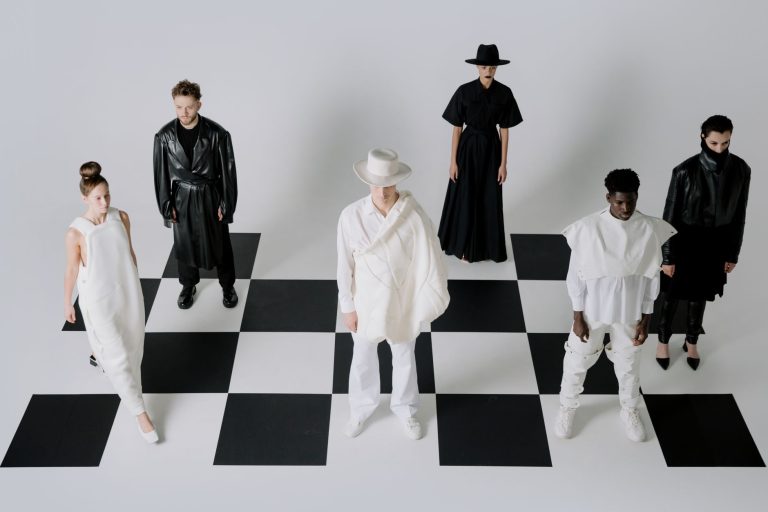 Stylish fashion models in black and white outfits on a chessboard backdrop. — Make your Lifestyle More Efficient With The 6th